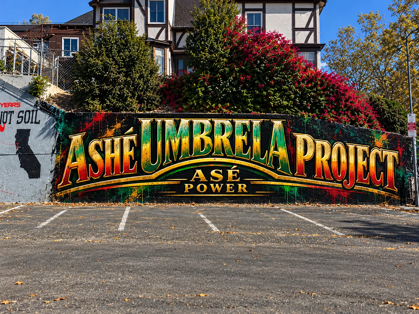 Wall mockup featuring a red, green and gold ASHÉ Umbrella Project mural